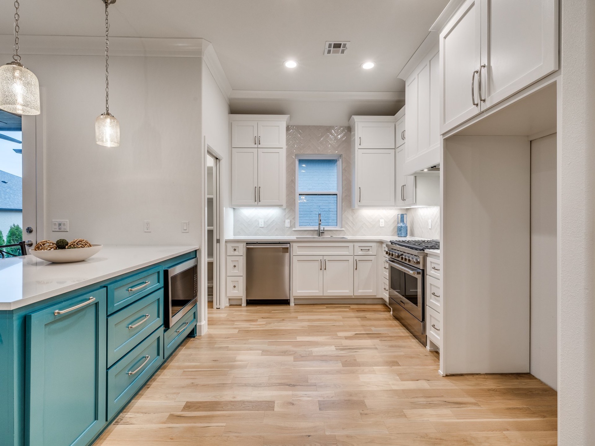 Chef's kitchen with teal cabinetry